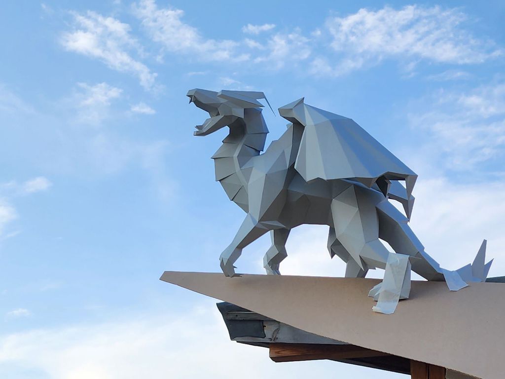 Sculptures of a lion and a dragon – symbols of the customer’s wife according to the Chinese horoscope for decorating the roof of a house, Ekaterinburg, Russia